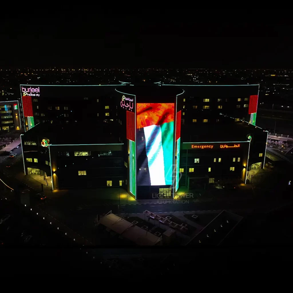 Hospital illuminated with National Day lighting decorations in patriotic colors